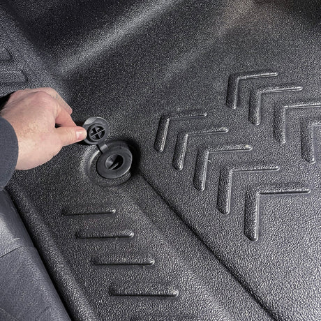 Close up image of floor drain being opened on driver side 