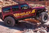 Red Jeep rock crawling on a trail in Moab