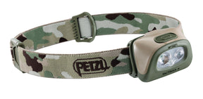A camouflage-patterned Petzl Tactikka+ headlamp with a green strap and buckle.