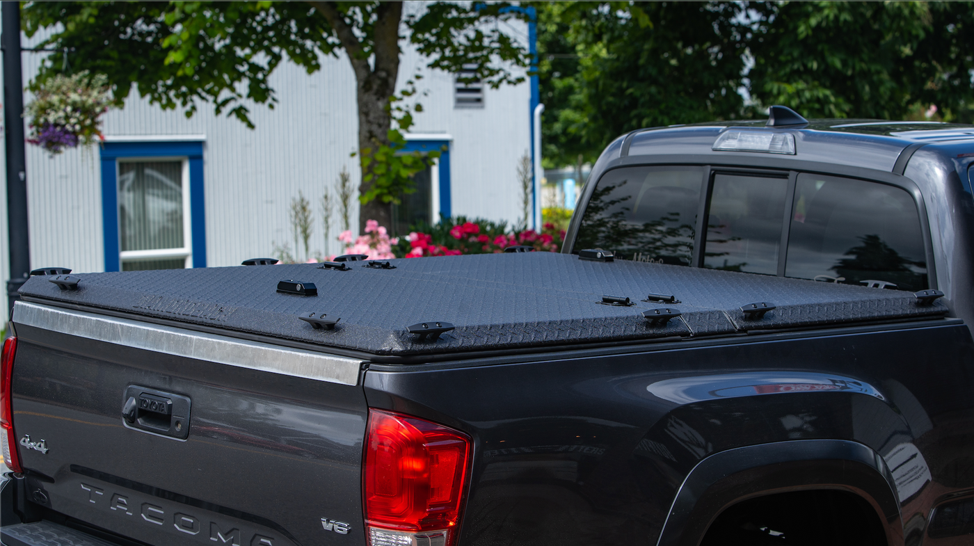 DiamondBack tonneau cover installed on a black Tacoma