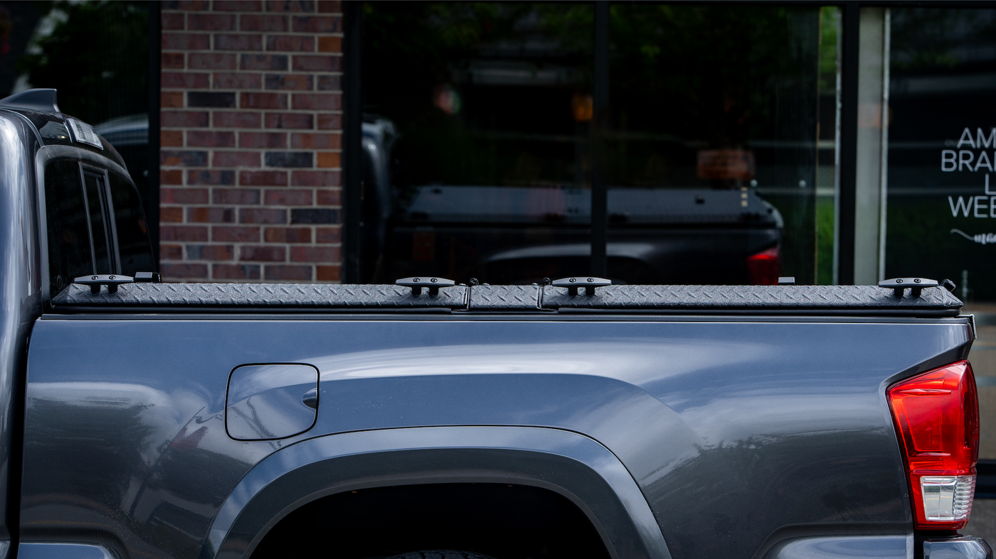 DiamondBack HD tonneau cover sitting snug on a black Tacoma truck