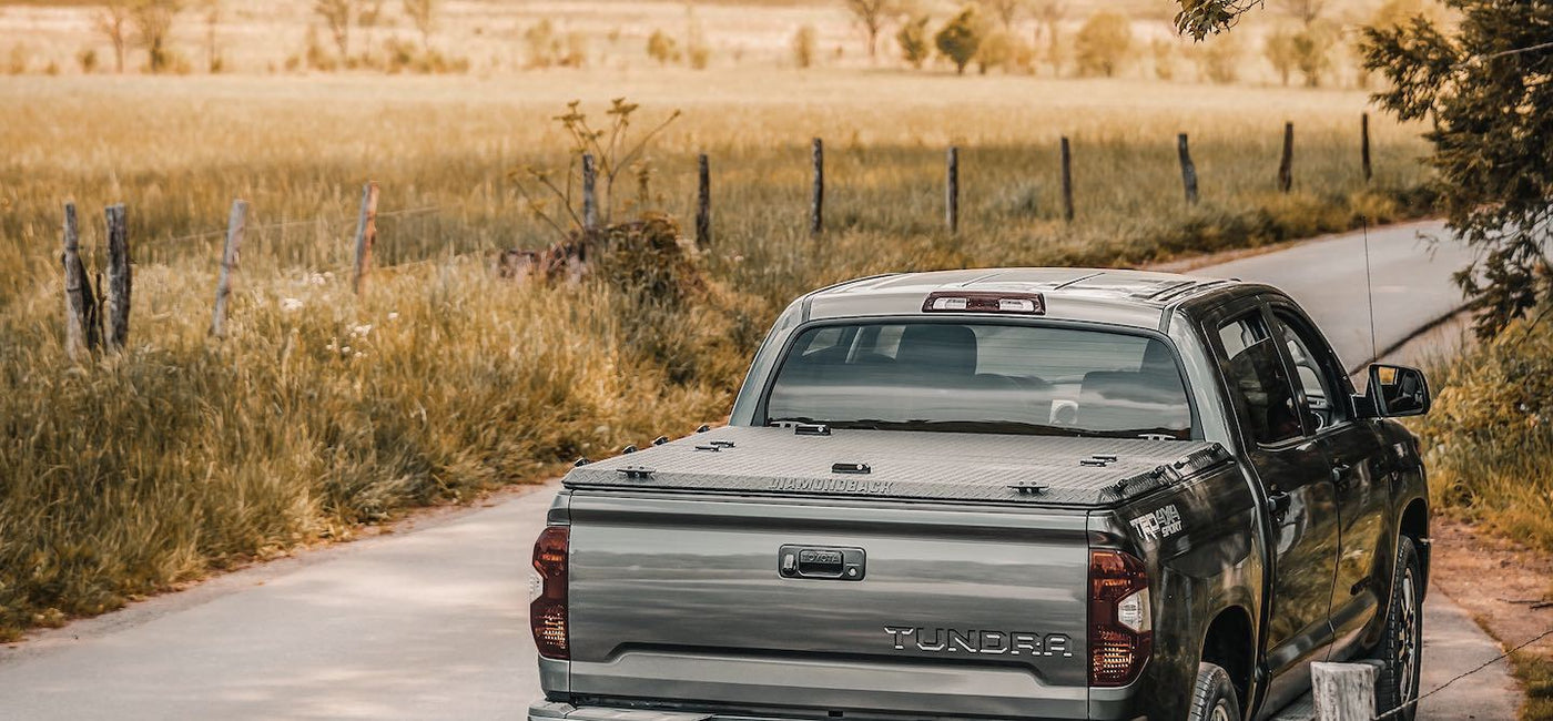 DiamondBack HD Tonneau Cover on a silver Tacoma on a back road in Canada. 